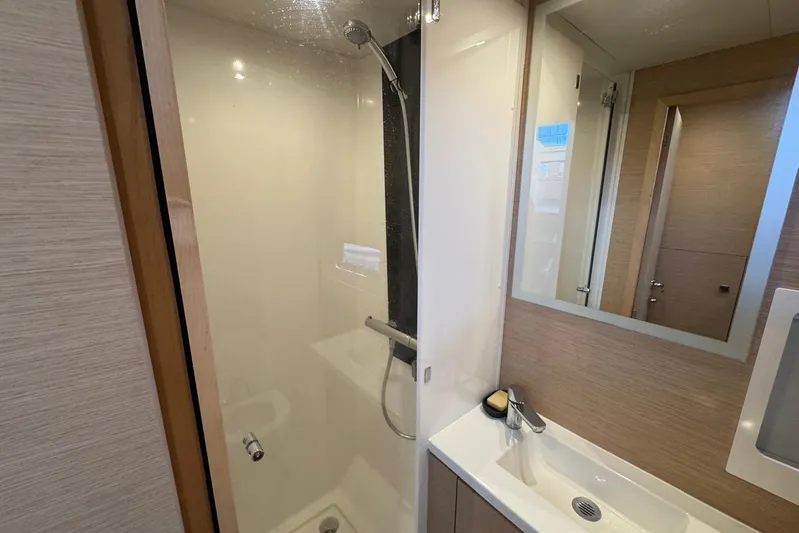 November Xiii Yacht Photos Pics Bathroom interior of 2019 Fountaine Pajot MY 44 yacht, featuring shower and sink.