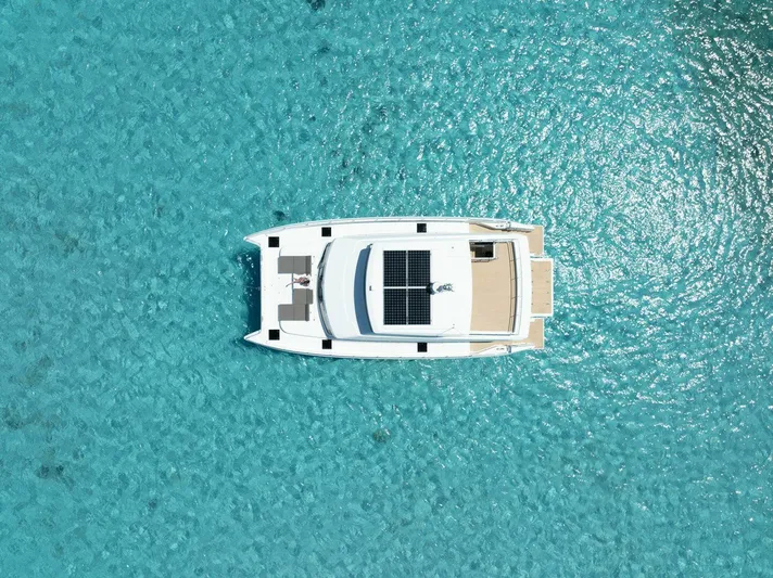 53f Iliad 2026 Yacht Photos Pics Aerial view of ILIAD 53F yacht on clear turquoise water, 2026 model.