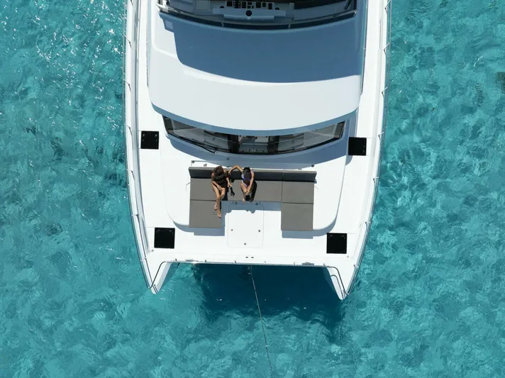 53f Iliad 2026 Yacht Photos Pics Aerial view of ILIAD 53F yacht, 2026 model, on clear turquoise water.