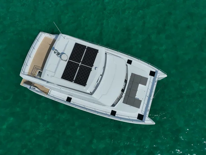 53f Iliad 2026 Yacht Photos Pics Aerial view of 2026 ILIAD 53F yacht with solar panels on turquoise water.