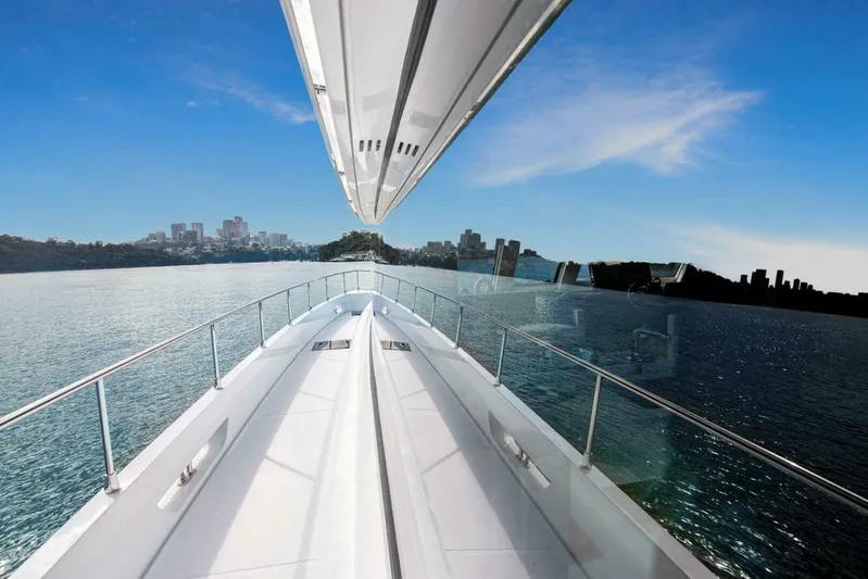 53f Iliad 2026 Yacht Photos Pics Luxury ILIAD 53F yacht cruising on a sunny day, city skyline in the background.