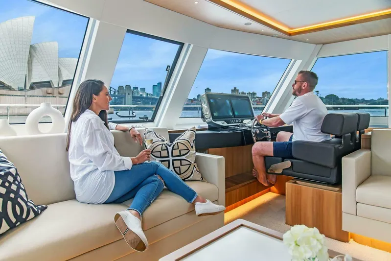 53f Iliad 2026 Yacht Photos Pics Couple enjoying a luxurious ride on a 2026 ILIAD 53F yacht with city views.