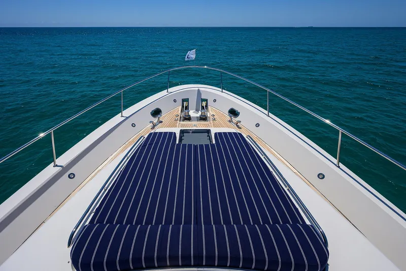 Jule Yacht Photos Pics Bow view of 2005 Pacific Mariner 85 yacht with striped sunbed on open sea.