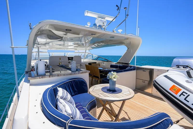 Jule Yacht Photos Pics Luxurious 2005 Pacific Mariner 85 yacht deck with seating, table, and ocean view.