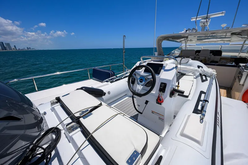 Jule Yacht Photos Pics 2005 Pacific Mariner 85 yacht deck with steering wheel, ocean view, and city skyline.