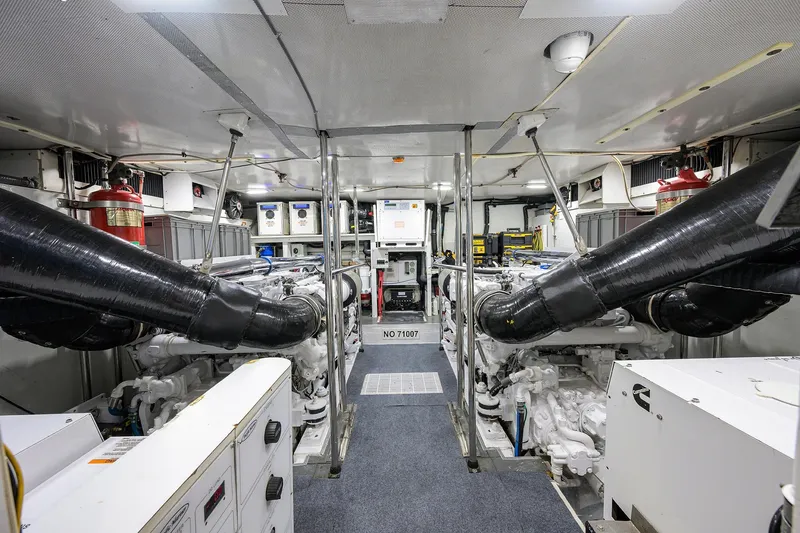 Jule Yacht Photos Pics Engine room of a 2005 Pacific Mariner 85 yacht, featuring dual engines and equipment.