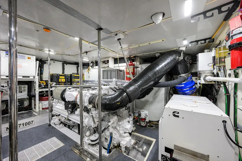 Jule Yacht Photos Pics Engine room of a 2005 Pacific Mariner 85 yacht, showcasing machinery and equipment.