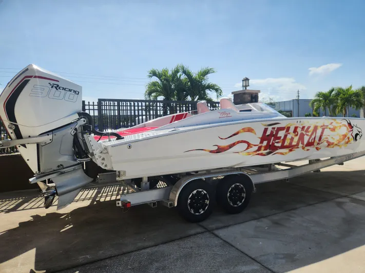  Yacht Photos Pics 2022 HellCat 32 Wide Body boat on trailer, featuring bold graphics and powerful engine.