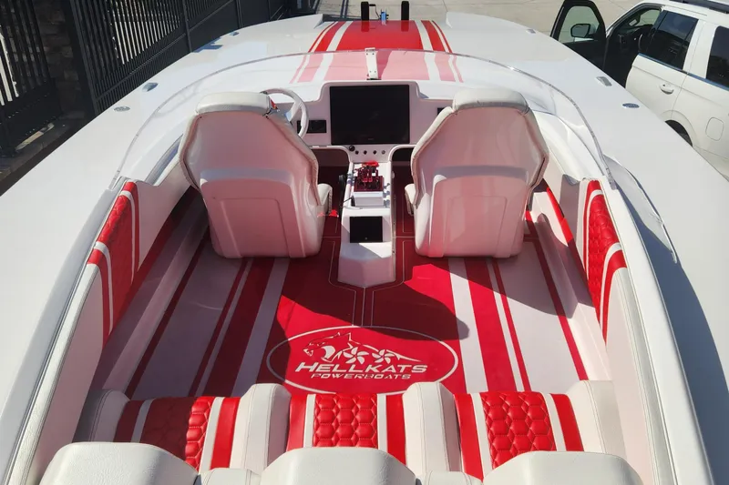  Yacht Photos Pics 2022 HellCat 32 Wide Body boat interior with red and white seating and dashboard.