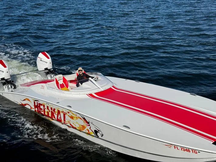  Yacht Photos Pics 2022 HellCat 32 Wide Body speedboat with red accents cruising on open water.