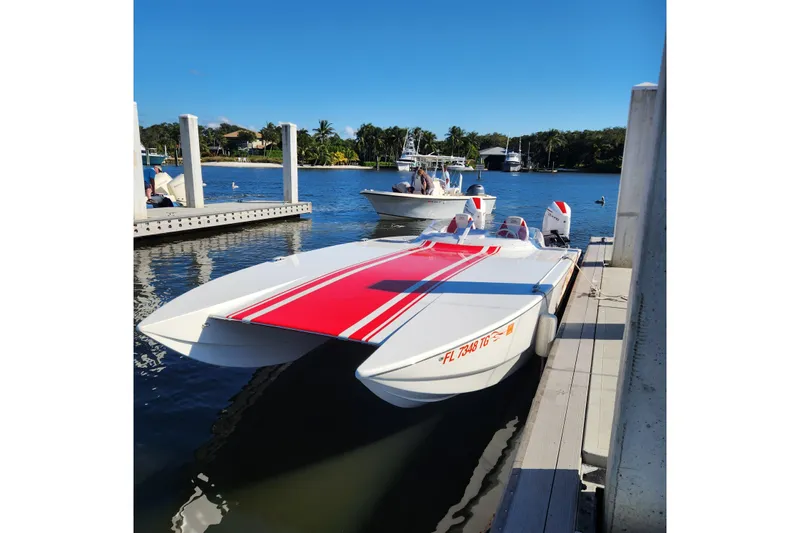  Yacht Photos Pics 2022 HellCat 32 Wide Body boat docked, featuring sleek design and vibrant red accents.