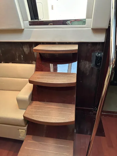 Be A Blessing II Yacht Photos Pics Interior stairs of 2009 Sea Ray 4300 Sundancer yacht with wooden steps and beige seating.