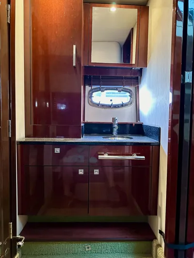 Be A Blessing II Yacht Photos Pics Luxurious 2009 Sea Ray 4300 Sundancer yacht bathroom with wood cabinetry and porthole window.