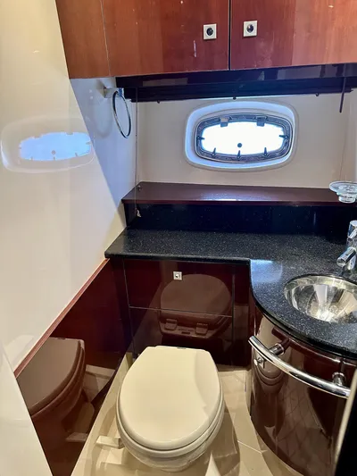 Be A Blessing II Yacht Photos Pics Luxurious bathroom in 2009 Sea Ray 4300 Sundancer yacht with modern fixtures and porthole window.