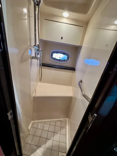 Be A Blessing II Yacht Photos Pics Luxurious shower area in 2009 Sea Ray 4300 Sundancer yacht, featuring modern fixtures and porthole window.