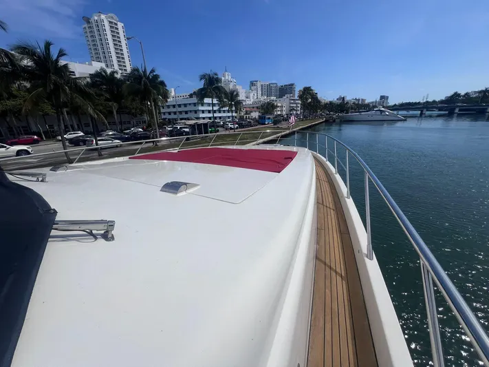  Yacht Photos Pics Azimut Leonardo 98 yacht deck view, 2004 model, docked near palm-lined waterfront.