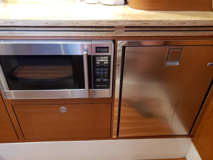  Yacht Photos Pics 2016 Mystic Powerboats M4200 kitchen with microwave and stainless steel fridge.