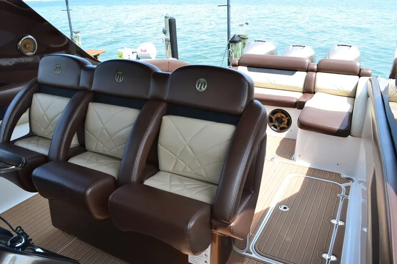  Yacht Photos Pics Luxurious seating on 2016 Mystic Powerboats M4200, featuring elegant brown and cream upholstery.