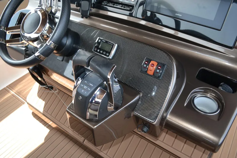  Yacht Photos Pics 2016 Mystic Powerboats M4200 helm with modern controls and carbon fiber accents.