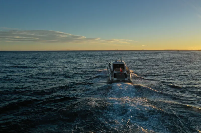 Carbon Copy V Yacht Photos Pics Luxury yacht Lazzara LSX 75 cruising at sunset, 2009 model.