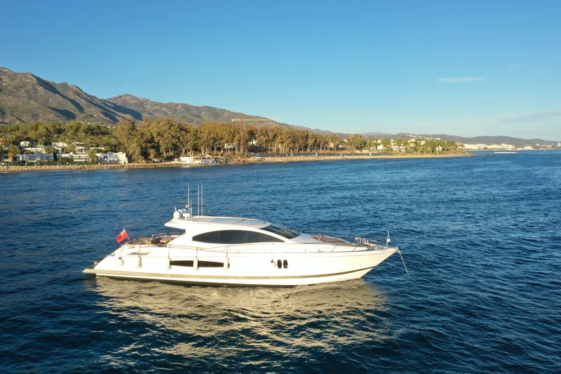 Carbon Copy V Yacht Photos Pics Luxury 2009 Lazzara LSX 75 yacht cruising near scenic coastline.