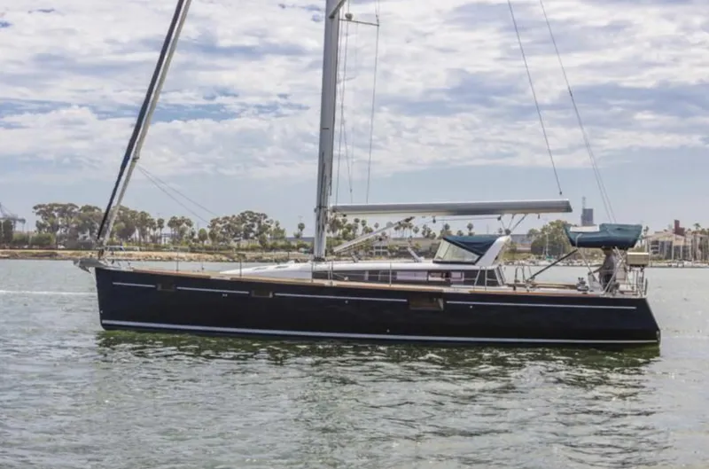 Blue Sky Yacht Photos Pics 2012 Beneteau Sense 50 sailboat on calm water, side view.