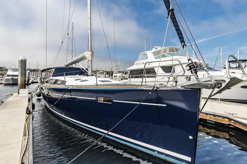 Blue Sky Yacht Photos Pics 2012 Beneteau Sense 50 yacht docked at marina, blue hull, clear sky.