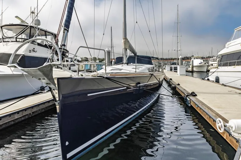 Blue Sky Yacht Photos Pics 2012 Beneteau Sense 50 yacht docked at marina, sleek design, calm water reflection.