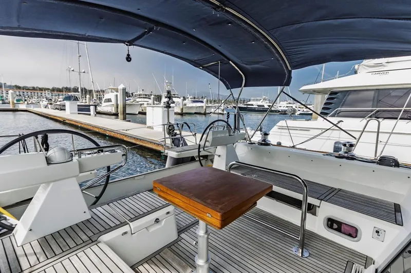 Blue Sky Yacht Photos Pics 2012 Beneteau Sense 50 yacht cockpit with dual steering wheels, docked in marina.
