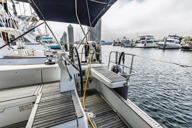 Blue Sky Yacht Photos Pics 2012 Beneteau Sense 50 yacht docked at marina, showcasing deck and steering wheel.