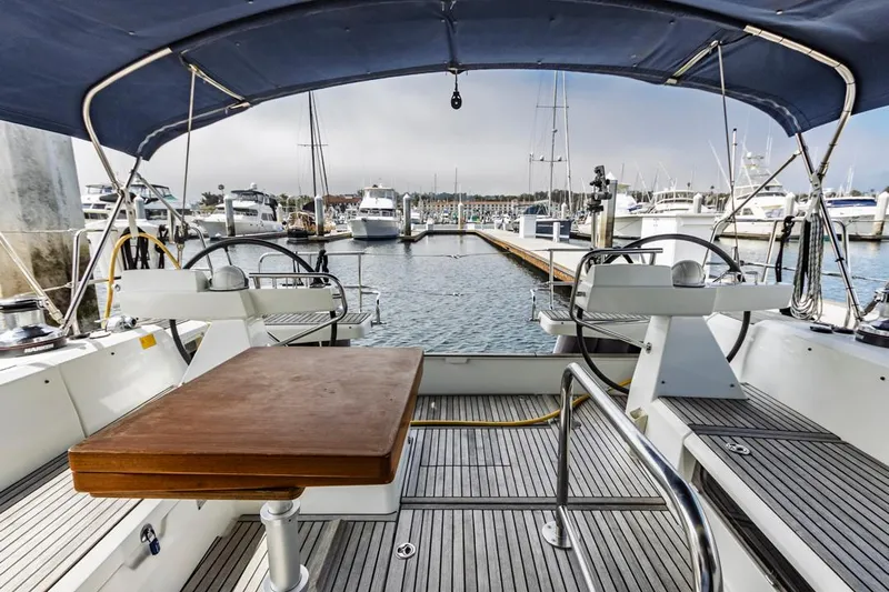 Blue Sky Yacht Photos Pics Beneteau Sense 50 sailboat cockpit with dual steering wheels, docked in a marina, 2012 model.