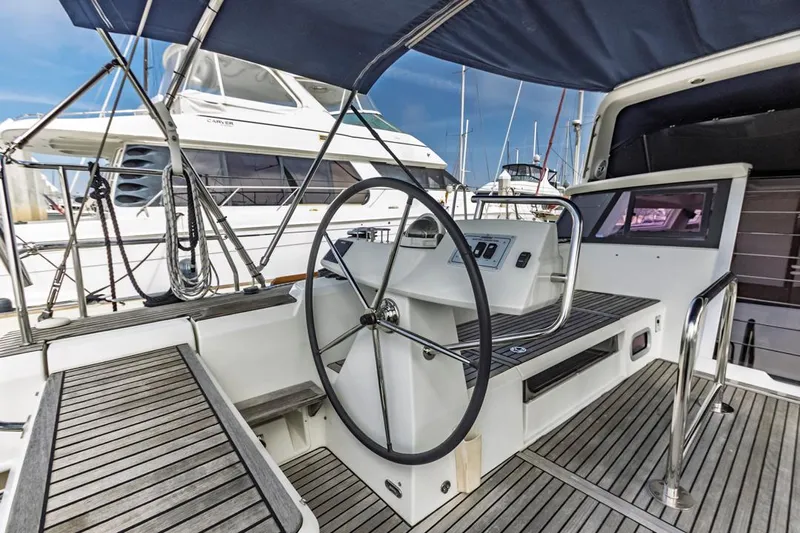 Blue Sky Yacht Photos Pics Cockpit of 2012 Beneteau Sense 50 yacht with steering wheel and wooden deck.