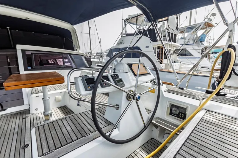 Blue Sky Yacht Photos Pics Cockpit of 2012 Beneteau Sense 50 yacht with steering wheel and navigation controls.