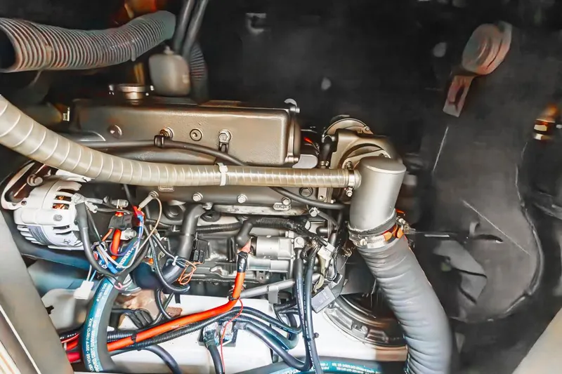 Blue Sky Yacht Photos Pics Engine compartment of a 2012 Beneteau Sense 50 yacht, showcasing intricate wiring and components.