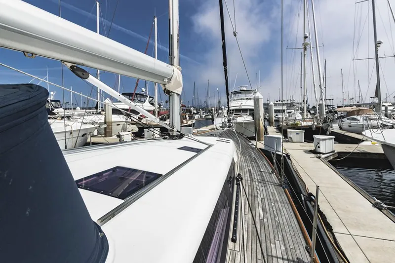 Blue Sky Yacht Photos Pics Beneteau Sense 50 yacht docked in a marina, 2012 model, surrounded by other boats.