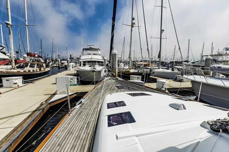 Blue Sky Yacht Photos Pics 2012 Beneteau Sense 50 yacht docked in a marina, surrounded by other boats.