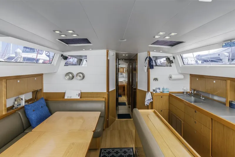 Blue Sky Yacht Photos Pics Interior of 2012 Beneteau Sense 50 yacht, featuring modern kitchen and dining area.