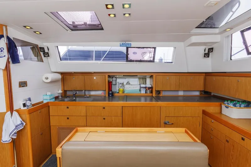 Blue Sky Yacht Photos Pics Interior of 2012 Beneteau Sense 50 yacht, featuring modern kitchen with wooden cabinetry.