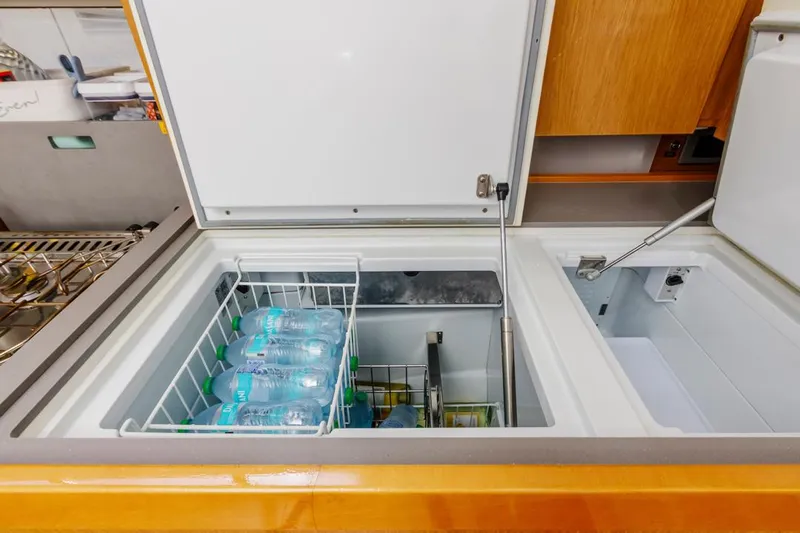 Blue Sky Yacht Photos Pics Interior view of 2012 Beneteau Sense 50 yacht's refrigerator with bottled water.
