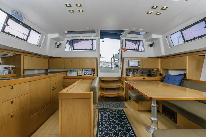 Blue Sky Yacht Photos Pics Interior of 2012 Beneteau Sense 50 yacht, featuring modern wood cabinetry and spacious seating area.