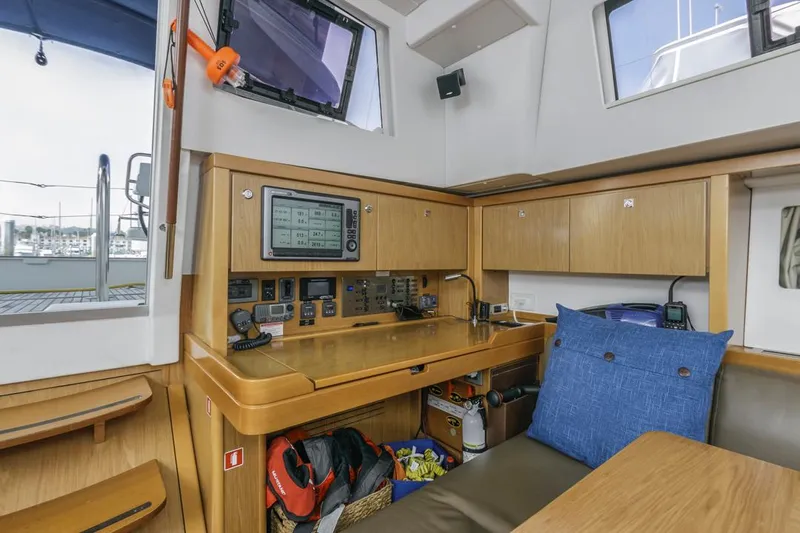 Blue Sky Yacht Photos Pics Interior of 2012 Beneteau Sense 50 yacht with navigation station and wooden cabinetry.