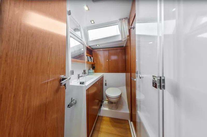 Blue Sky Yacht Photos Pics Luxurious bathroom interior of 2012 Beneteau Sense 50 yacht with wood accents and skylight.