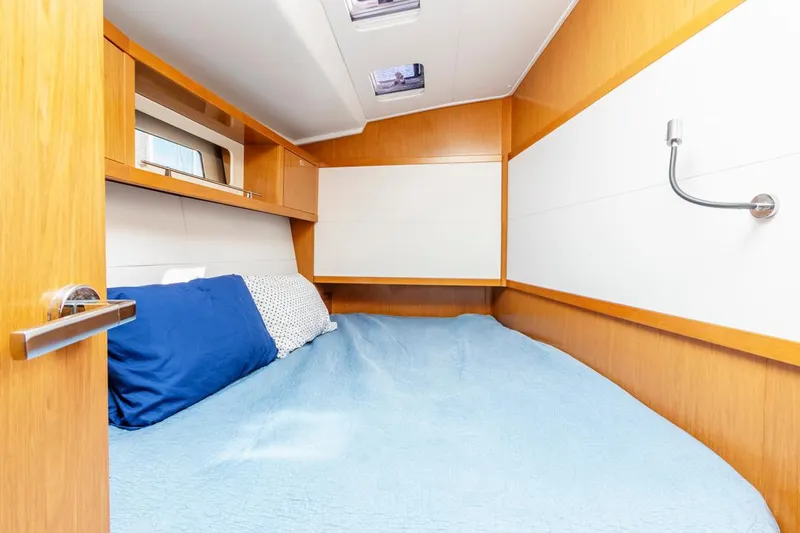 Blue Sky Yacht Photos Pics Cozy cabin interior of 2012 Beneteau Sense 50 yacht with blue bedding.