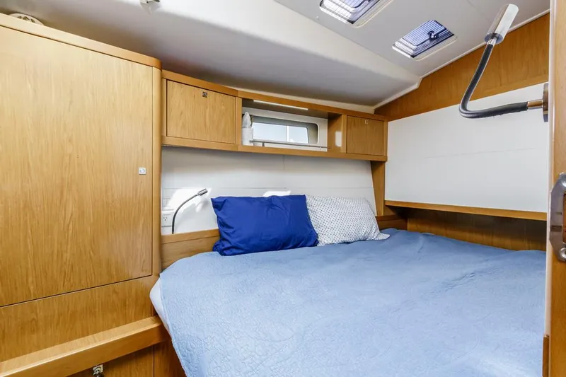 Blue Sky Yacht Photos Pics Cozy cabin interior of 2012 Beneteau Sense 50 yacht with blue bedding.