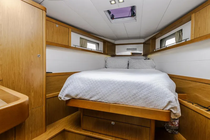 Blue Sky Yacht Photos Pics Luxurious cabin interior of 2012 Beneteau Sense 50 yacht with cozy bed and wooden finish.