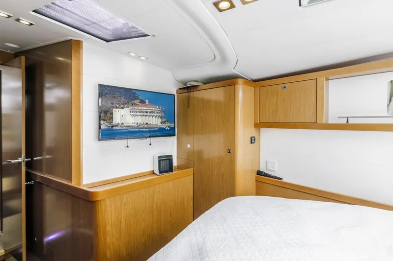 Blue Sky Yacht Photos Pics Luxurious interior of 2012 Beneteau Sense 50 yacht with wood finish and wall-mounted TV.
