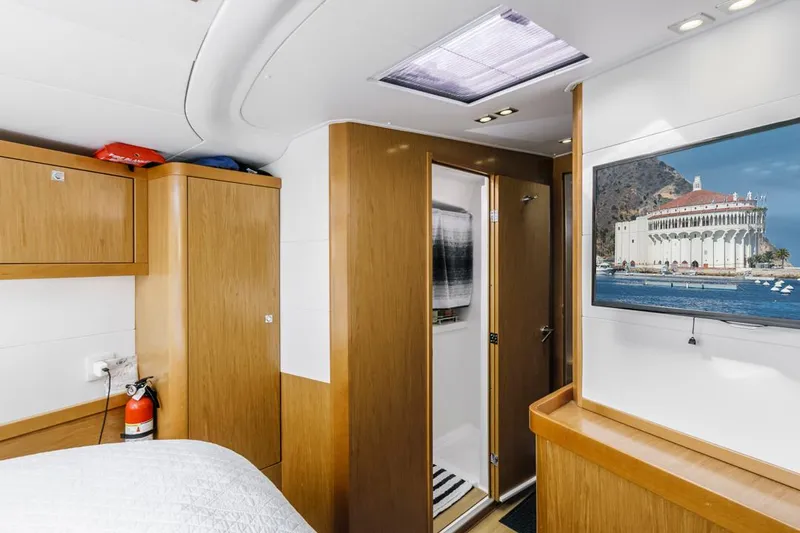 Blue Sky Yacht Photos Pics Interior of 2012 Beneteau Sense 50 yacht with wood finish and wall-mounted TV.