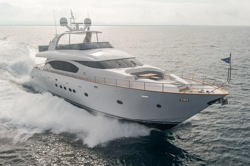  Yacht Photos Pics Luxurious 2015 Maiora 24S yacht cruising on open sea, showcasing sleek design and elegance.