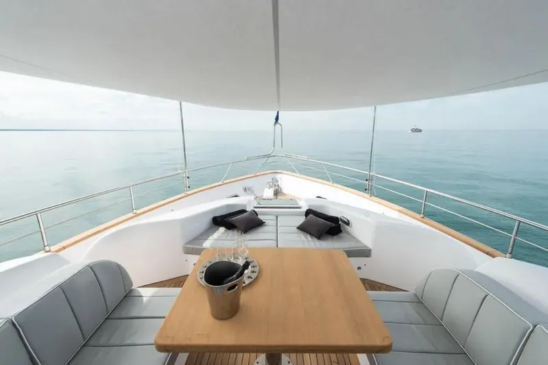  Yacht Photos Pics Luxurious 2015 Maiora 24S yacht deck with seating, table, and ocean view.