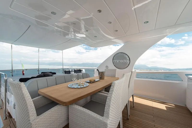  Yacht Photos Pics Luxurious 2015 Maiora 24S yacht deck with elegant dining setup and ocean view.